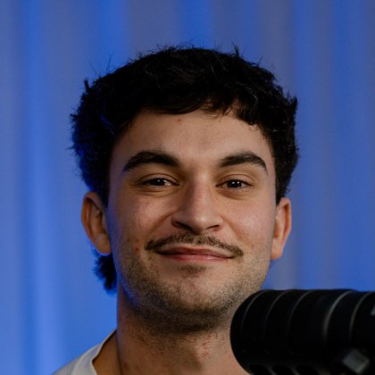 Bailey Williams, smiling, photographed at the studio table.